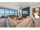 Bright living room with large sofa, ocean views and sleek ceiling fan at 5861 Gulf Of Mexico Dr, Longboat Key, FL 34228