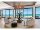 Living room with ocean views, contemporary decor, and plenty of natural light at 5861 Gulf Of Mexico Dr, Longboat Key, FL 34228