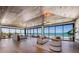 Bright open living and bedroom space featuring wood-paneled ceiling, modern furnishings, and full ocean view at 5861 Gulf Of Mexico Dr, Longboat Key, FL 34228