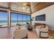 Bright living room with wood-paneled ceiling, modern furnishings, and a full ocean view at 5861 Gulf Of Mexico Dr, Longboat Key, FL 34228