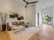 Cozy living room with modern decor, a leather sofa, and hardwood flooring at 5861 Gulf Of Mexico Dr, Longboat Key, FL 34228