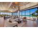 Relaxing open living space with full ocean view through walls of floor-to-ceiling glass windows at 5861 Gulf Of Mexico Dr, Longboat Key, FL 34228