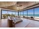 Bright bedroom featuring wood-paneled ceiling, modern furnishings, and full ocean view at 5861 Gulf Of Mexico Dr, Longboat Key, FL 34228