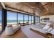 Bright bedroom featuring wood-paneled ceiling, modern furnishings, and a full ocean view at 5861 Gulf Of Mexico Dr, Longboat Key, FL 34228