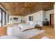 Spacious bedroom boasts a wood ceiling, and a view to a beautifully decorated living space at 5861 Gulf Of Mexico Dr, Longboat Key, FL 34228