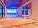 Covered outdoor living space with multiple pools, fountains, and views of the greenery beyond at 5861 Gulf Of Mexico Dr, Longboat Key, FL 34228