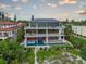 Modern three-story home boasting balconies, a private pool, and direct beach access at 5861 Gulf Of Mexico Dr, Longboat Key, FL 34228