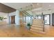 Modern staircase with glass railings and an adjacent wine storage area at 5861 Gulf Of Mexico Dr, Longboat Key, FL 34228