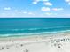 Aerial view of a beautiful beach with clear water and many people enjoying the sun at 6006 Midnight Pass Rd # 8, Sarasota, FL 34242