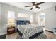 Main bedroom with king-size bed, walk-in closet, and ceiling fan at 6555 Blue Grosbeak Cir, Lakewood Ranch, FL 34202