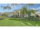 Single-story house with a two-car garage and tropical landscaping at 7506 Eaton Ct, University Park, FL 34201