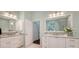 Bright bathroom featuring dual vanities, granite countertops, a walk-in shower, and plenty of natural light at 7506 Eaton Ct, University Park, FL 34201