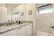 Modern bathroom features granite countertops, a tiled walk-in shower, and a large mirror at 7506 Eaton Ct, University Park, FL 34201
