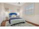 Cozy bedroom with plantation shutters, hardwood floors, wainscoting, and a plush bed at 7506 Eaton Ct, University Park, FL 34201
