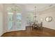 Bright dining area with hardwood floors, chandelier and views from windows with custom shutters at 7506 Eaton Ct, University Park, FL 34201