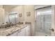 Spa-like bathroom with granite countertops and a large walk-in shower at 7506 Eaton Ct, University Park, FL 34201