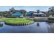 Aerial view of a clubhouse near a golf course and lake at 7506 Eaton Ct, University Park, FL 34201