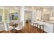Bright kitchen featuring a dining area, breakfast bar with modern countertops, and hardwood floors at 7506 Eaton Ct, University Park, FL 34201