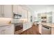 Modern kitchen featuring stainless appliances, granite counters, and a view of the living room at 7506 Eaton Ct, University Park, FL 34201