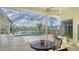 Relaxing pool and lanai area with lake view at 7506 Eaton Ct, University Park, FL 34201