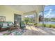 Covered patio overlooks the lake and features wicker furniture at 7506 Eaton Ct, University Park, FL 34201
