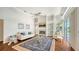 Open-concept living room featuring a fireplace, comfortable seating, and views of the pool area at 7506 Eaton Ct, University Park, FL 34201