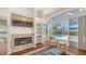 Living room featuring a fireplace, built-in shelving and sliding glass doors leading to the pool at 7506 Eaton Ct, University Park, FL 34201