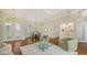 Open-concept living room featuring hardwood floors, comfortable seating, and views of the dining room at 7506 Eaton Ct, University Park, FL 34201