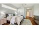 Inviting bedroom featuring tray ceilings, hardwood floors, and calming color palette at 7506 Eaton Ct, University Park, FL 34201