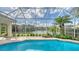 Relaxing pool and patio area with screened enclosure, overlooking a serene lake at 7506 Eaton Ct, University Park, FL 34201