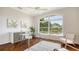 Inviting office with hardwood floors, large windows overlooking the lake, and custom built-ins at 7506 Eaton Ct, University Park, FL 34201