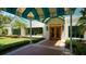 Attractive clubhouse entrance with a covered walkway and landscaping at 7506 Eaton Ct, University Park, FL 34201