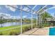 Screened poolside patio boasts tranquil lake views and beautiful landscaping at 7506 Eaton Ct, University Park, FL 34201