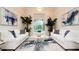 Bright living room with two white sofas and large windows at 9260 Swaying Branch Rd, Sarasota, FL 34241