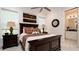 Spacious bedroom with ensuite bathroom, large windows and dark wood furniture at 9260 Swaying Branch Rd, Sarasota, FL 34241