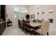 Formal dining room with a large table, statement lighting, and built-in display niches at 9260 Swaying Branch Rd, Sarasota, FL 34241