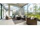 Relaxing screened lanai with wicker furniture and a fire pit at 9260 Swaying Branch Rd, Sarasota, FL 34241