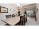 Bright dining room with a large table, decorative lighting and views into Gathering room at 9260 Swaying Branch Rd, Sarasota, FL 34241