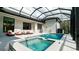 Resort-style pool and spa with covered patio and lounge chairs at 9260 Swaying Branch Rd, Sarasota, FL 34241