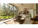 Outdoor kitchen with stainless steel appliances and screened enclosure at 9260 Swaying Branch Rd, Sarasota, FL 34241