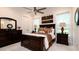 Comfortable bedroom with a double bed, dark wood furniture, and ceiling fan at 9260 Swaying Branch Rd, Sarasota, FL 34241