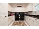 Bright laundry room with modern washer and dryer, granite countertops, and ample cabinetry at 9260 Swaying Branch Rd, Sarasota, FL 34241