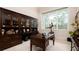 Spacious home office with built-in bookcases and a large desk, providing ample workspace at 9260 Swaying Branch Rd, Sarasota, FL 34241