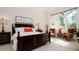 Spacious main bedroom with a king-size bed and sitting area at 9260 Swaying Branch Rd, Sarasota, FL 34241