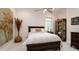 Serene bedroom featuring a bed, decorative wall art, and ample natural light at 9260 Swaying Branch Rd, Sarasota, FL 34241