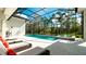 Inviting pool and spa area with screened enclosure and lounge chairs at 9260 Swaying Branch Rd, Sarasota, FL 34241