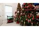Room with two decorated Christmas trees and holiday gift wrap at 9260 Swaying Branch Rd, Sarasota, FL 34241