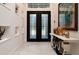 Bright entry with double doors and unique wall decor at 9260 Swaying Branch Rd, Sarasota, FL 34241