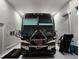 Front view of a luxury RV inside a pristine garage at 9260 Swaying Branch Rd, Sarasota, FL 34241
