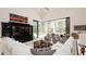 Open living space featuring a sectional sofa and pool view at 9260 Swaying Branch Rd, Sarasota, FL 34241